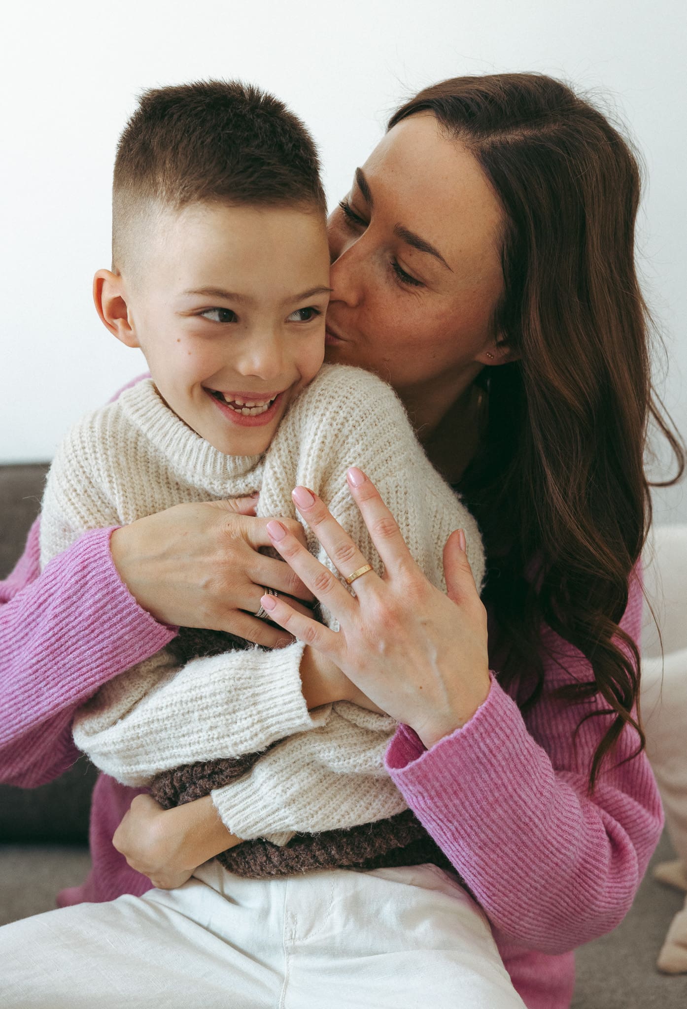 mom kissing her son for a family session in Montreal