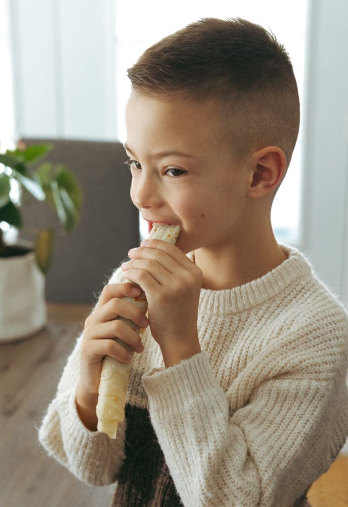 kid eating breakfast for a family session