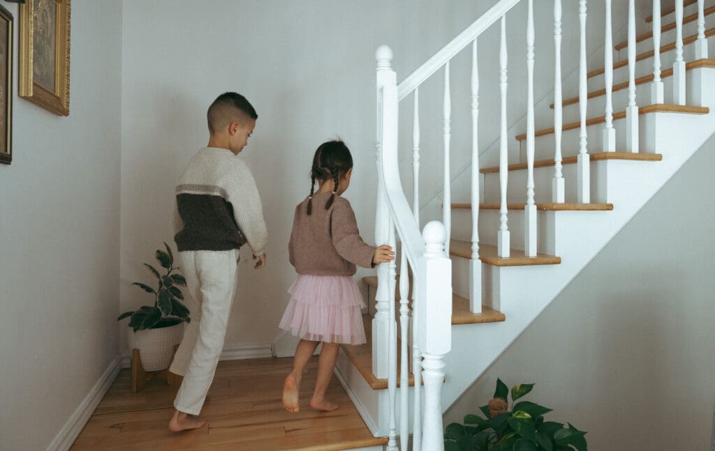kids going up the stairs for a in-home family photoshoot in Montreal