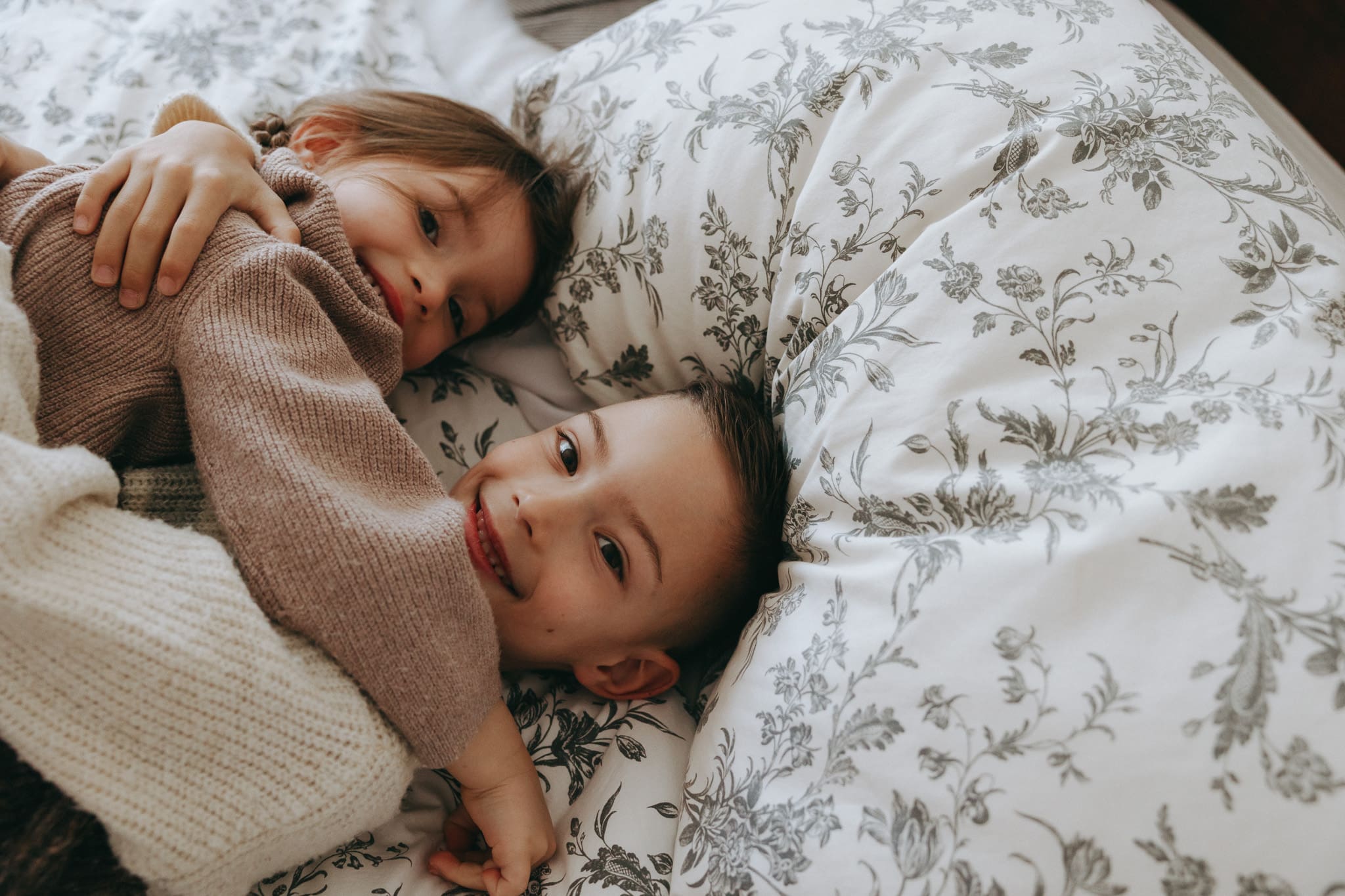 Siblings hugging for a candid photoshoot in Montreal