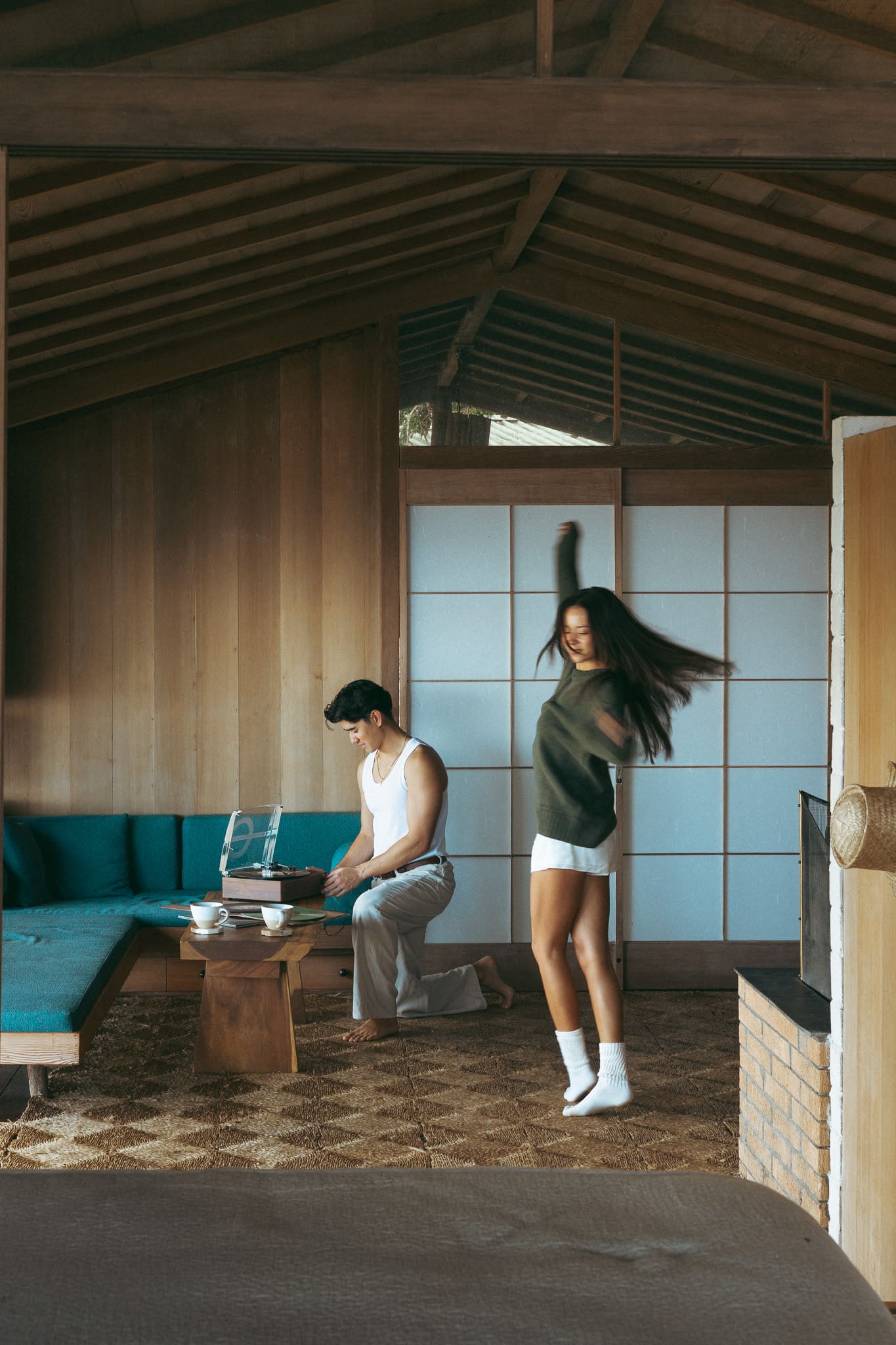 a couple dancing at the cottage and playing records 
