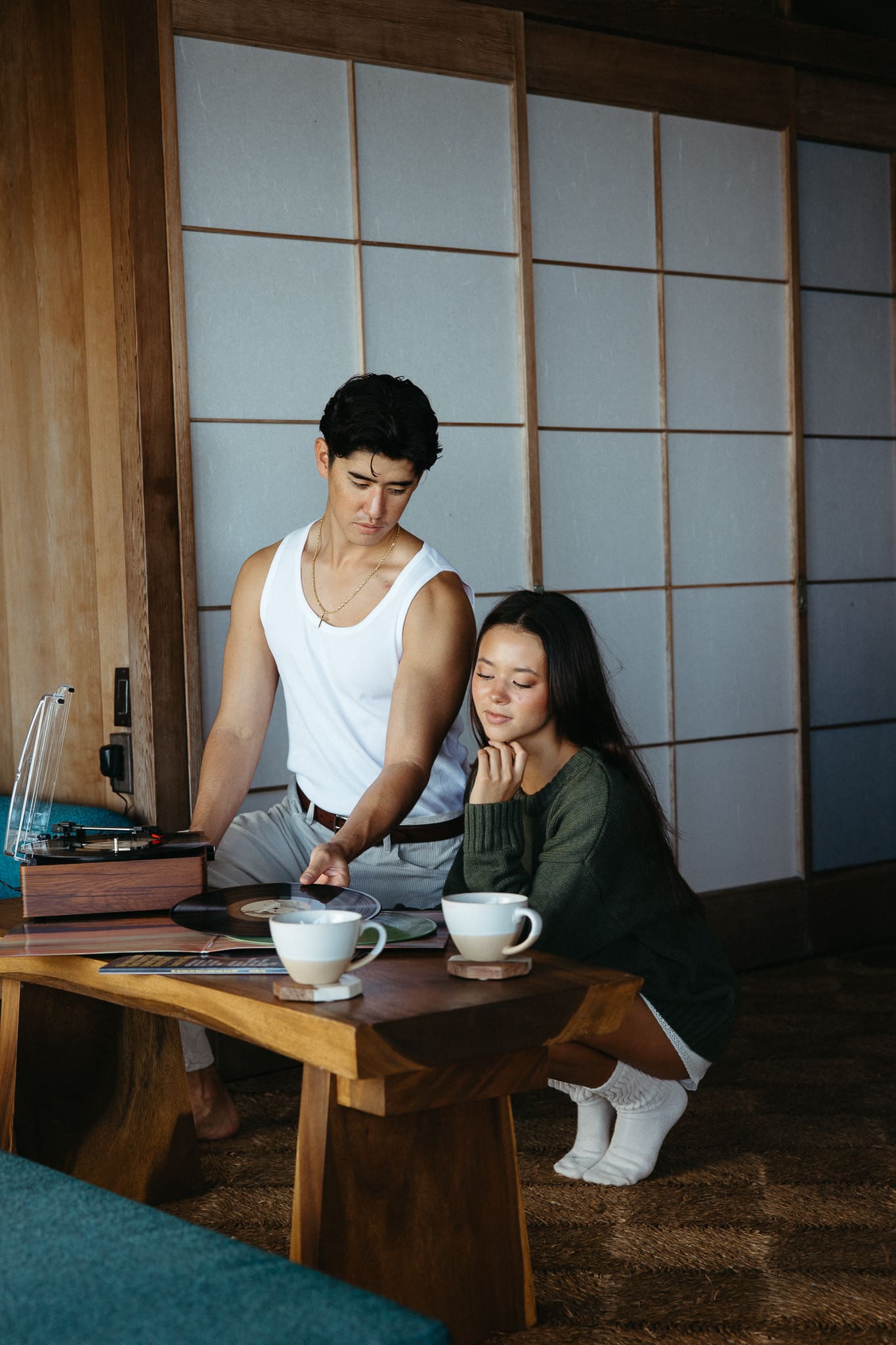 A couple playing records and drinking coffee for an in-home couples session