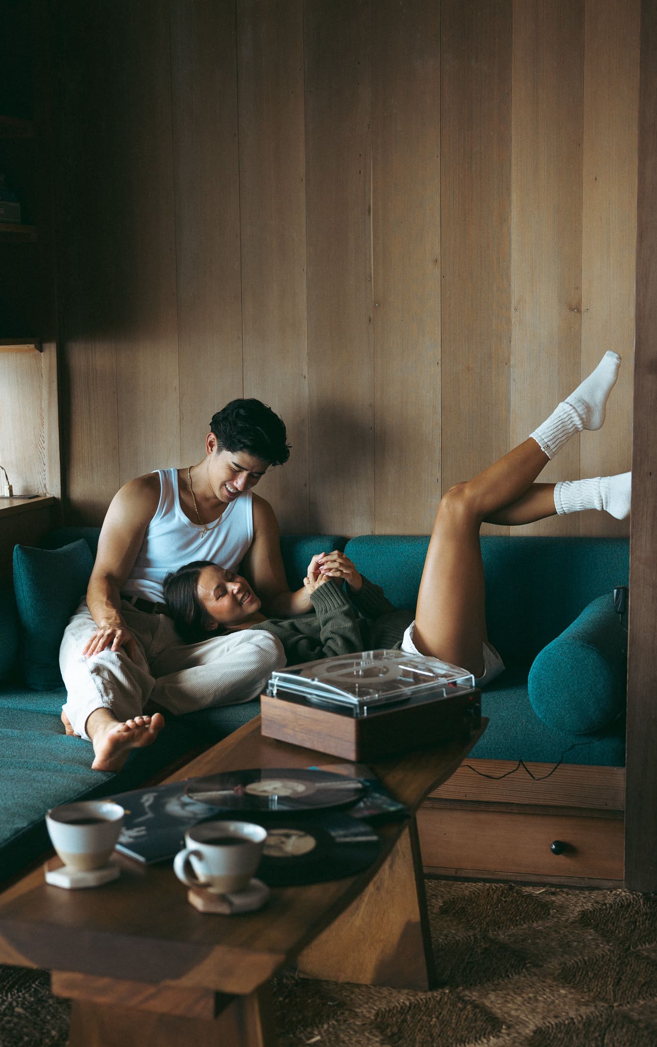 a couple laying on the couch listening to music for a cinematic couples session