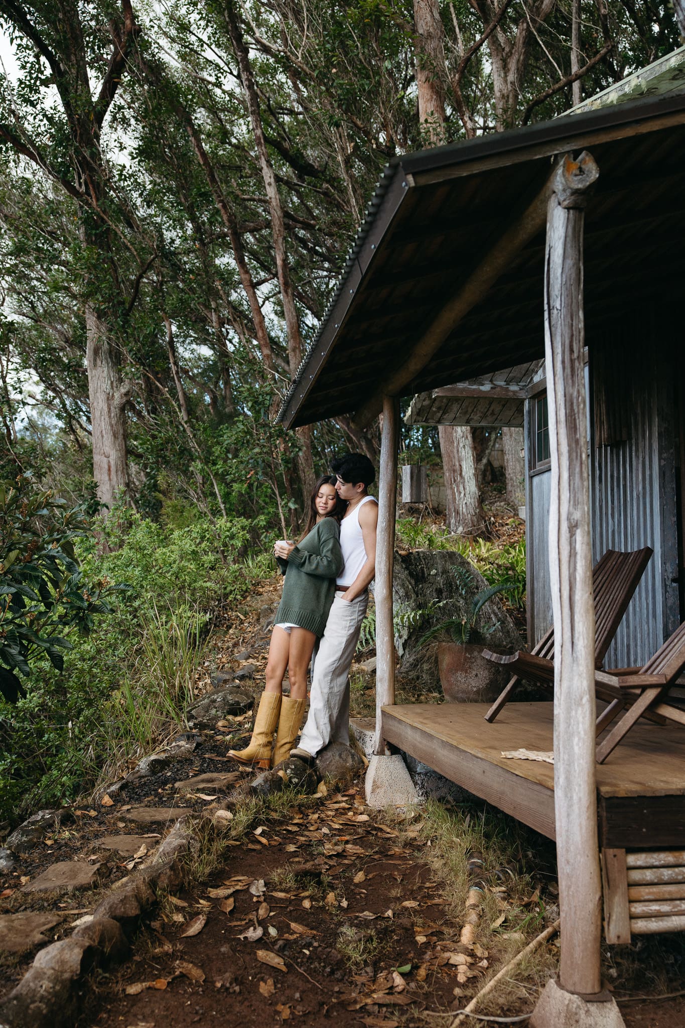 a couple standing outside of the cottage and having coffee for a couples session