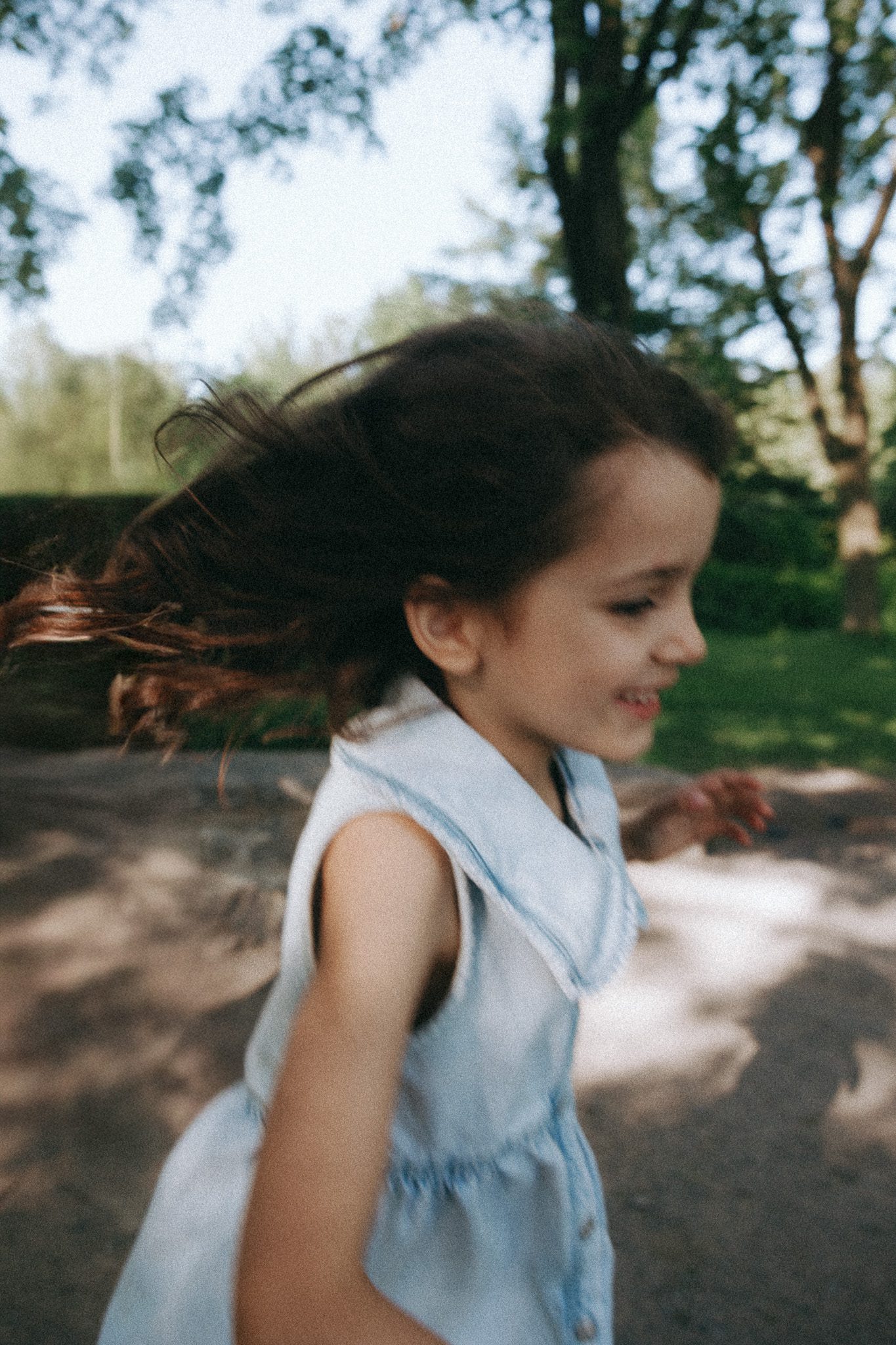 Child running around the garden during a family session in Montreal, Canada