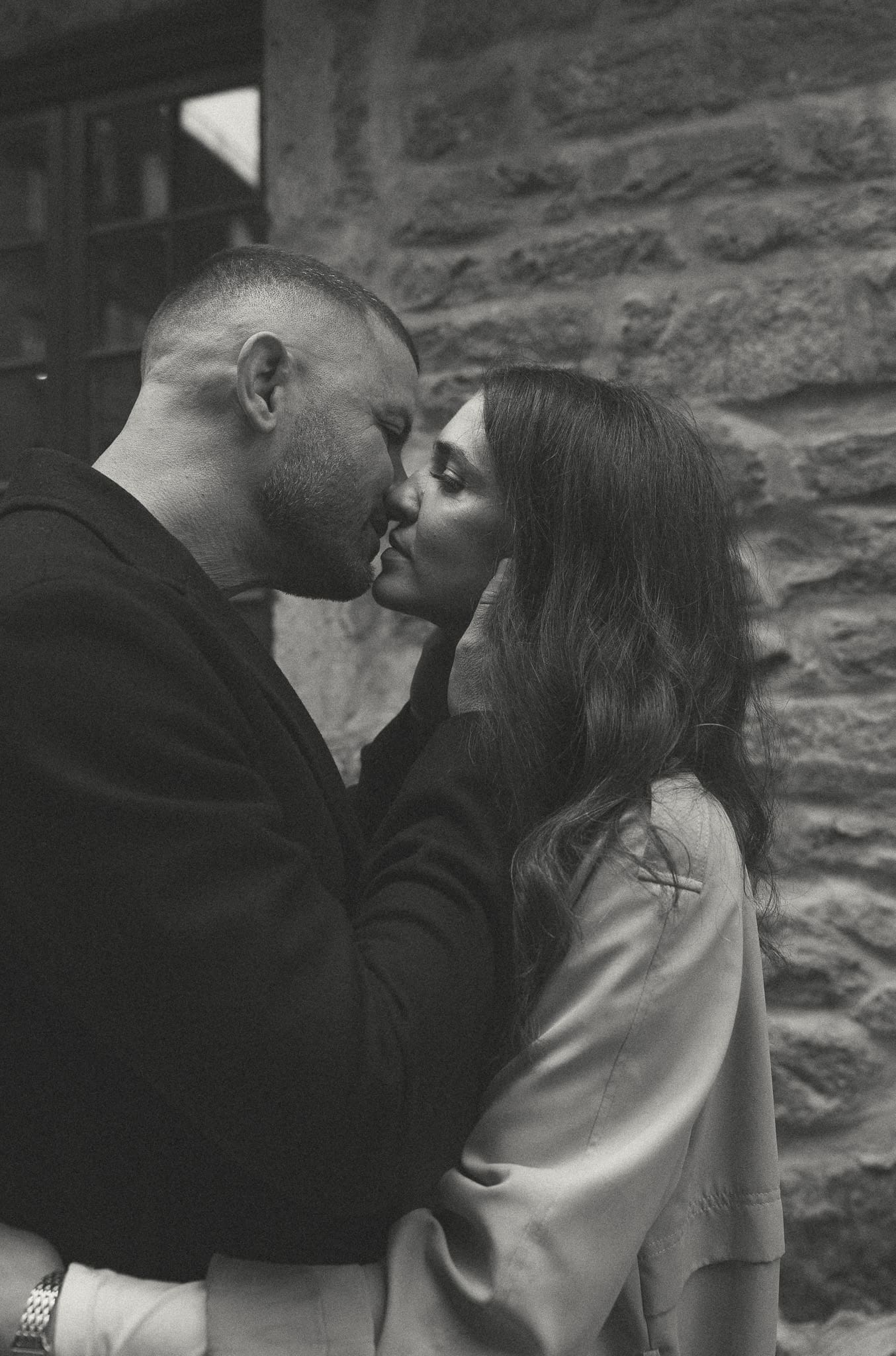 A couple leaning in for a kiss in downtown Montreal