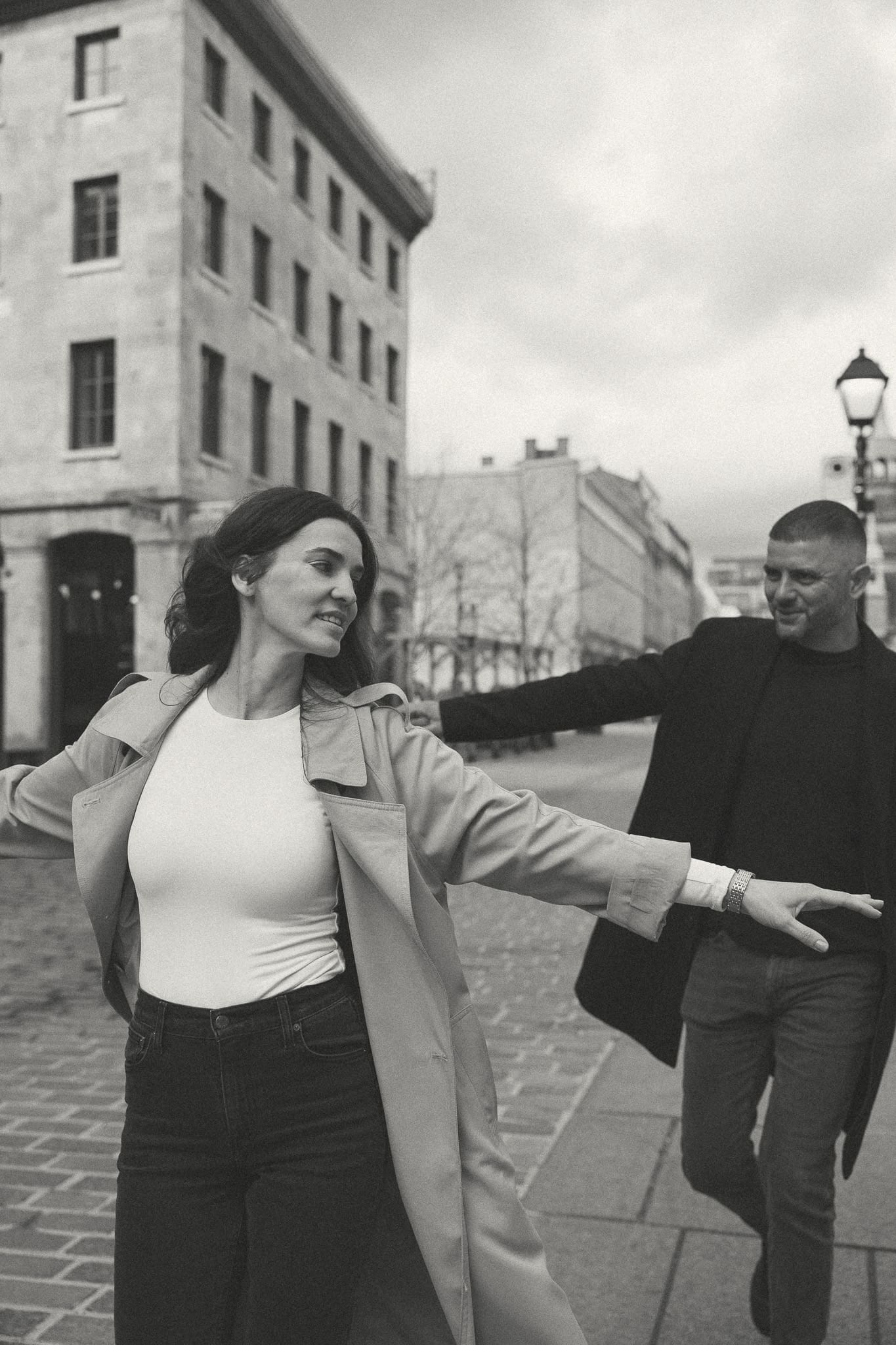 A couple running around downtown Montreal for a photo session
