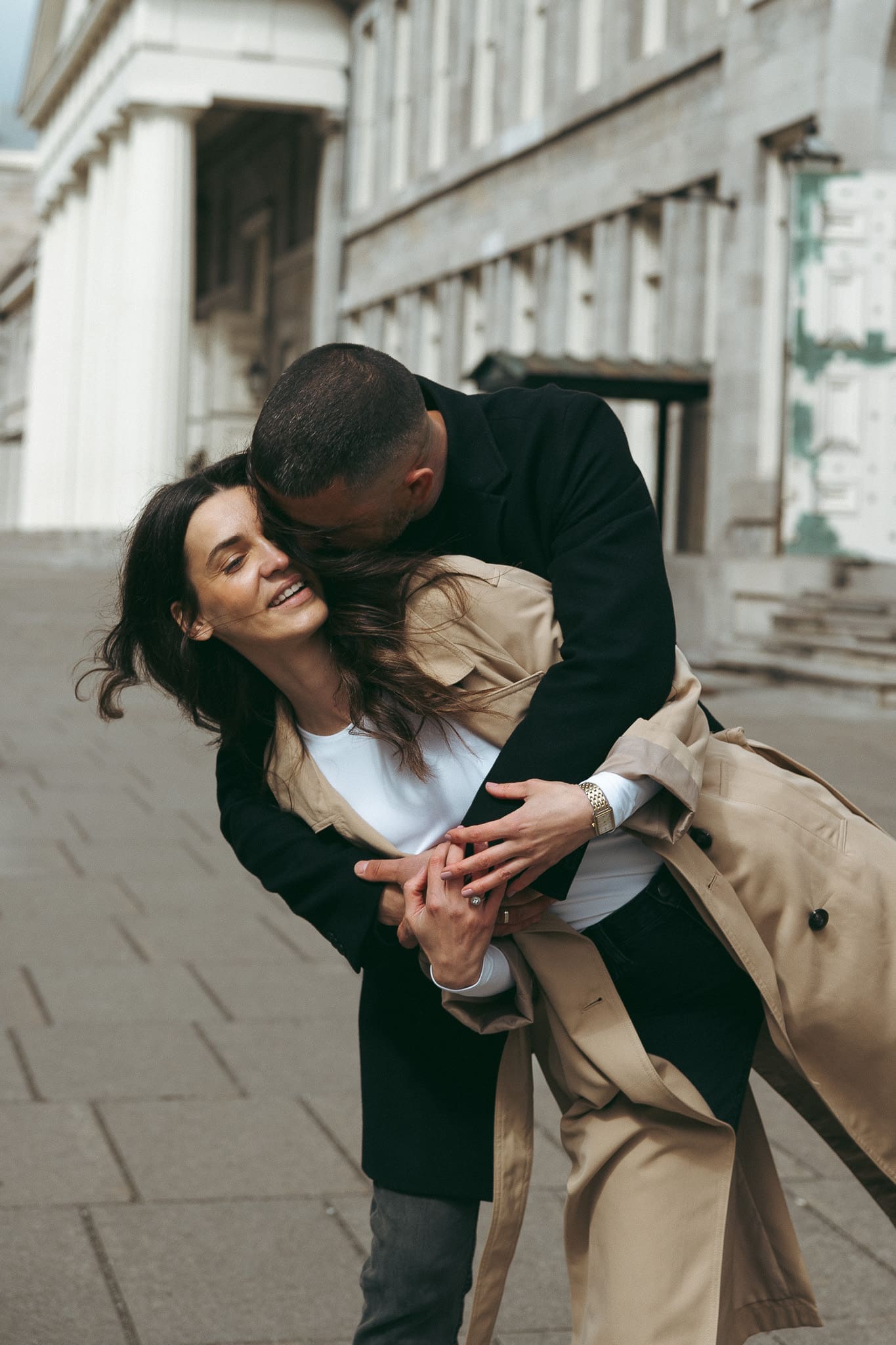 A couple smiling and hugging each other for a photo shoot in downtown Montreal 
