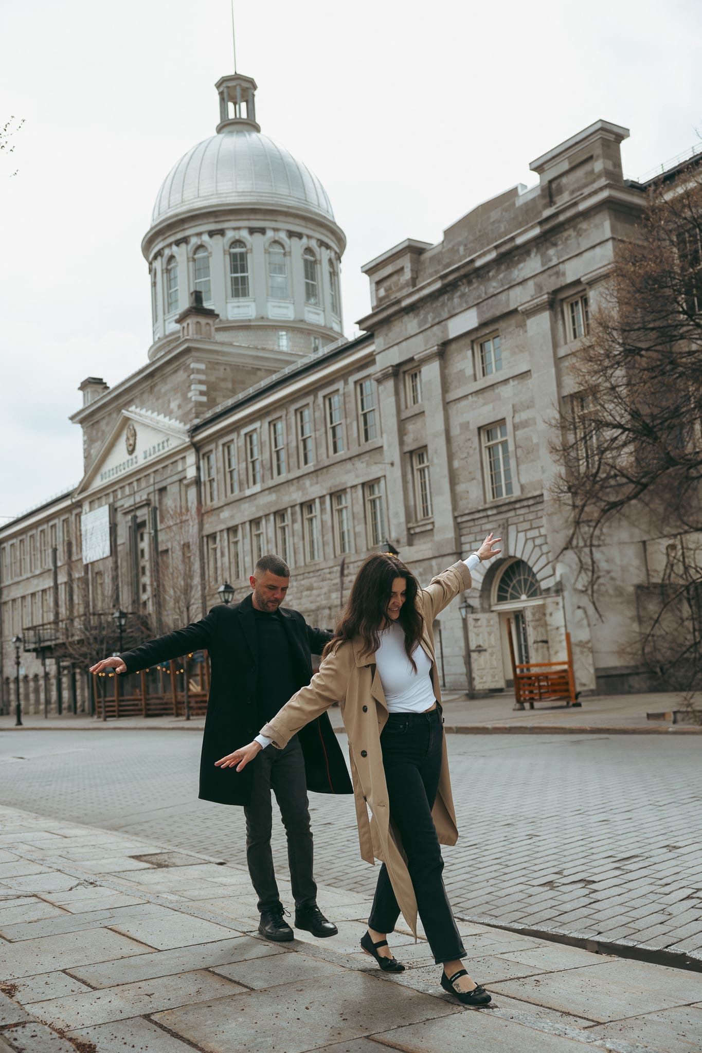 A couple running around Old Port montreal during a photoshoot
