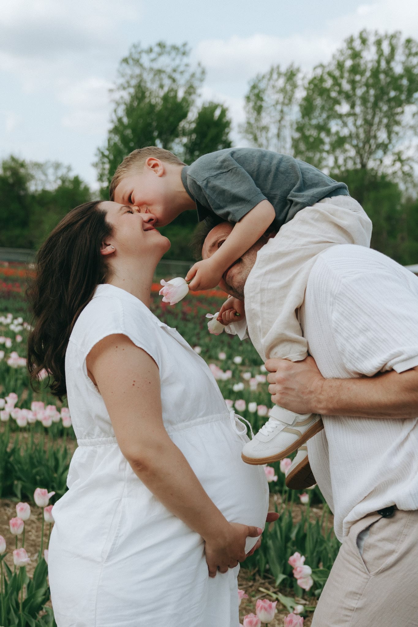 Family leaning in for a kiss all together during a family session in Montreal 