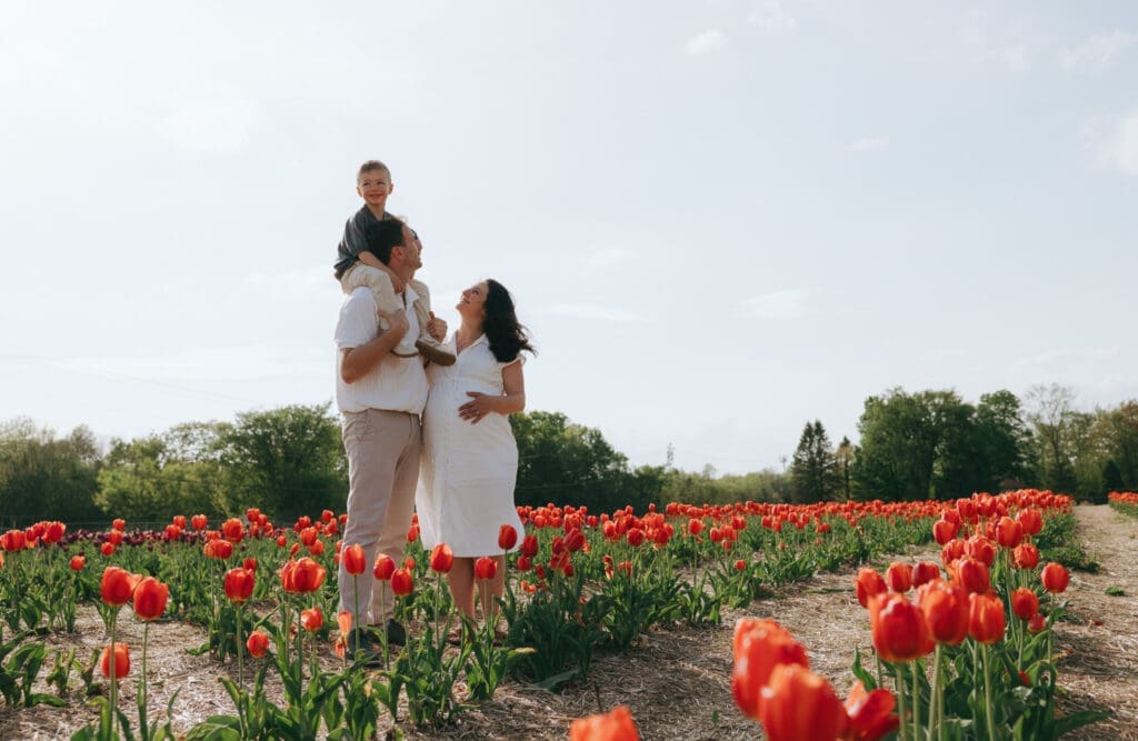 Family standing in the tulip fields for a family photo in Montreal